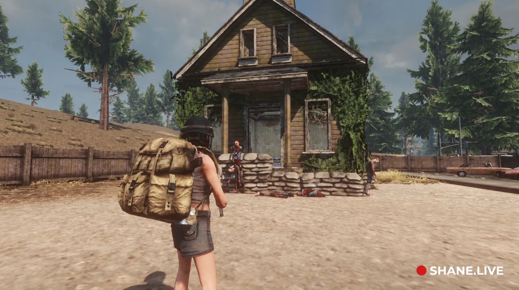 Historische WarZ-Gameplay-Szene von ShaneTSGTV mit Zombies vor einem Haus, mit Shane.live-Wasserzeichen